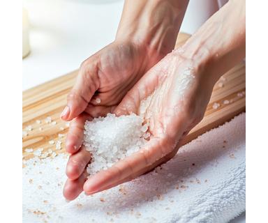 Applying sea salt body scrub